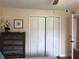 A bedroom with ample closet space, and doorway to another room at 222 Georgetown Dr # C, Casselberry, FL 32707