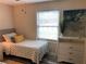 Bright bedroom featuring a twin bed, a three drawer dresser and a window at 222 Georgetown Dr # C, Casselberry, FL 32707