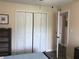 A bedroom featuring ample closet space, wood-look flooring, and natural light at 222 Georgetown Dr # C, Casselberry, FL 32707