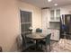 Cozy dining area with a round table and seating, located near the kitchen and stainless steel refrigerator at 222 Georgetown Dr # C, Casselberry, FL 32707
