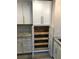 Pantry with pull out shelves and white cabinets, offering ample storage space in this stylish and modern kitchen at 222 Georgetown Dr # C, Casselberry, FL 32707