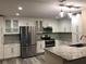 Modern kitchen featuring white cabinets, stainless steel appliances, and granite countertops, offering a sleek and functional space at 222 Georgetown Dr # C, Casselberry, FL 32707