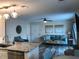 Open-concept living area featuring a kitchen island, modern lighting, and comfortable seating, creating an inviting space at 222 Georgetown Dr # C, Casselberry, FL 32707