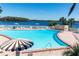 Relaxing community pool with ample seating and lake views at 222 Georgetown Dr # C, Casselberry, FL 32707