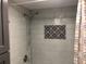 A detailed shower with a shower head and a built-in decorative tiled nook at 222 Georgetown Dr # C, Casselberry, FL 32707