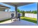 Covered back porch with outdoor seating, ideal for relaxing and enjoying the well-maintained backyard at 2285 Mystic Maze Ln, Clermont, FL 34715