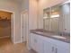 Bathroom with double sink vanity and a walk-in shower at 2285 Mystic Maze Ln, Clermont, FL 34715