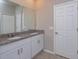Bathroom with dual sinks and a granite countertop at 2285 Mystic Maze Ln, Clermont, FL 34715