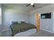 Comfortable bedroom with large window, TV and a door to the bathroom at 2285 Mystic Maze Ln, Clermont, FL 34715