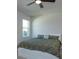 Cozy bedroom features a large bed and a view from the window at 2285 Mystic Maze Ln, Clermont, FL 34715