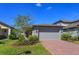 Charming single Gathering home featuring a brick paver driveway and attached two car garage at 2285 Mystic Maze Ln, Clermont, FL 34715