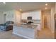 Bright open concept kitchen with white cabinets, granite countertops, and stainless steel appliances at 2285 Mystic Maze Ln, Clermont, FL 34715