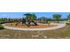 Community playground featuring slides and play equipment, perfect for Gathering fun in a landscaped setting at 2285 Mystic Maze Ln, Clermont, FL 34715