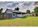 The backyard of the house features grass, a screened porch, and a wooden fence at 2516 Albury Ave, Deltona, FL 32738
