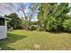 A sprawling backyard with lush grass and mature trees, perfect for outdoor activities and relaxation at 2516 Albury Ave, Deltona, FL 32738