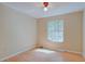 Bright, vacant bedroom with a window providing natural light and a ceiling fan at 2516 Albury Ave, Deltona, FL 32738