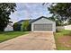 Charming one-story home with a large driveway and attached two car garage and mature shrubbery at 2516 Albury Ave, Deltona, FL 32738