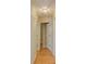 Hallway with hardwood floors and neutral-colored walls, leading to other rooms in the house at 2516 Albury Ave, Deltona, FL 32738