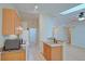 Eat-in kitchen features tile floors, wood cabinets, a breakfast bar, and white appliances at 2516 Albury Ave, Deltona, FL 32738