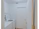 A tidy laundry room features a modern washing machine and a white door, providing convenience and functionality at 2516 Albury Ave, Deltona, FL 32738