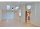 Spacious living room featuring hardwood floors, skylights, and an elegant chandelier near the kitchen at 2516 Albury Ave, Deltona, FL 32738