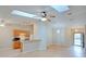 Open-concept living space with skylights and laminate floors flows into a well-lit kitchen at 2516 Albury Ave, Deltona, FL 32738