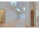 Bright living room showcasing hardwood floors, skylights, and access to other rooms in the home at 2516 Albury Ave, Deltona, FL 32738