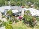Stunning aerial view of the home featuring a beautiful outdoor patio and lush landscaping with palm trees at 264 Balfour Dr, Winter Park, FL 32792
