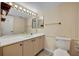 Bathroom features vanity with ample storage, large mirror, and wallpaper at 264 Balfour Dr, Winter Park, FL 32792