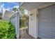 Private gated entrance with beautiful floral details and stylish number plaque at 264 Balfour Dr, Winter Park, FL 32792