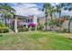Beautiful home with lush landscaping including bougainvillea and a green lawn at 264 Balfour Dr, Winter Park, FL 32792