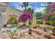 Beautifully landscaped garden featuring colorful bougainvillea, a fountain, and outdoor seating at 264 Balfour Dr, Winter Park, FL 32792