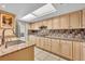 Bright kitchen featuring tile backsplash, granite counters, and updated cabinets at 264 Balfour Dr, Winter Park, FL 32792
