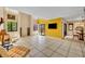 Spacious living room with tile floors, yellow accent wall, balcony access, and an open layout at 264 Balfour Dr, Winter Park, FL 32792