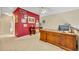 Spacious office with a large wooden desk, red accent wall and lots of art at 264 Balfour Dr, Winter Park, FL 32792