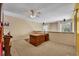 Bright office space with a large wooden desk, ceiling fan and natural light from the windows at 264 Balfour Dr, Winter Park, FL 32792