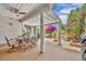 Covered outdoor patio with dining set and tranquil garden views at 264 Balfour Dr, Winter Park, FL 32792