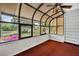 Sunroom with windows offering views of the landscaped backyard at 264 Balfour Dr, Winter Park, FL 32792