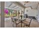 Covered patio with dining set and lush garden view at 264 Balfour Dr, Winter Park, FL 32792