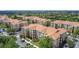 A beautiful aerial view of multiple apartment buildings featuring large parking lots and lush trees at 2781 Almaton Loop # 404, Kissimmee, FL 34747
