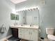 Bright bathroom featuring a large mirror with decorative lighting and plenty of counter space at 2781 Almaton Loop # 404, Kissimmee, FL 34747