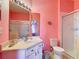 Pink bathroom featuring a vanity, toilet, and glass enclosed shower at 2781 Almaton Loop # 404, Kissimmee, FL 34747