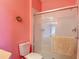 Cozy bathroom featuring a glass shower door and bright pink walls for a vibrant touch at 2781 Almaton Loop # 404, Kissimmee, FL 34747