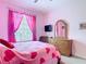 Pink themed bedroom with a large window, a double bed, and a dresser at 2781 Almaton Loop # 404, Kissimmee, FL 34747