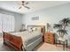 Comfortable bedroom with ceiling fan, serene colors, and matching nightstands flanking the bed at 2781 Almaton Loop # 404, Kissimmee, FL 34747