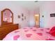 Pink themed bedroom showing furniture and a view to the ensuite bathroom at 2781 Almaton Loop # 404, Kissimmee, FL 34747