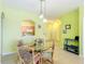 Open concept kitchen and dining area with a glass table and decorative chairs for relaxed meals at 2781 Almaton Loop # 404, Kissimmee, FL 34747