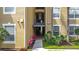 Exterior shot of building entrance, with address sign, colorful landscaping, and natural lighting at 2781 Almaton Loop # 404, Kissimmee, FL 34747