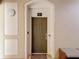 View of a well-lit front door with an electronic entry, a decorative welcome mat, and security features at 2781 Almaton Loop # 404, Kissimmee, FL 34747