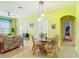 View of a vibrant, sunlit living room showcasing tropical decor and open layout at 2781 Almaton Loop # 404, Kissimmee, FL 34747